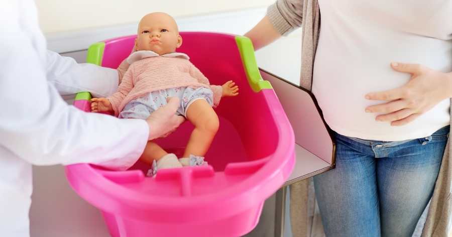 mom learning how to bathe a baby