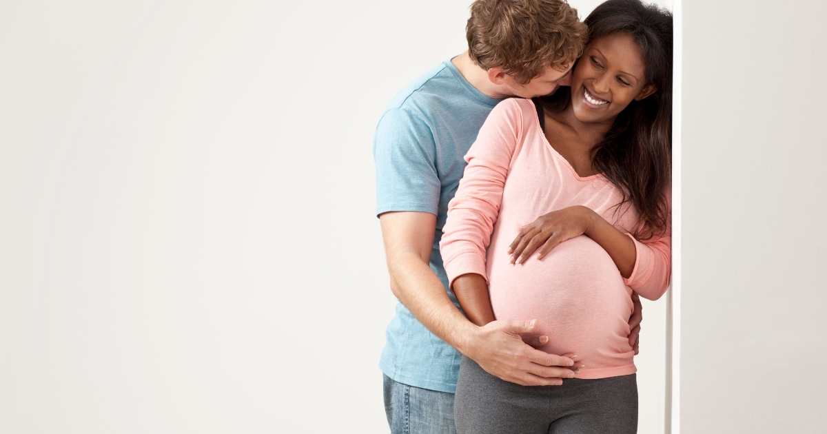 pregnant couple cuddling