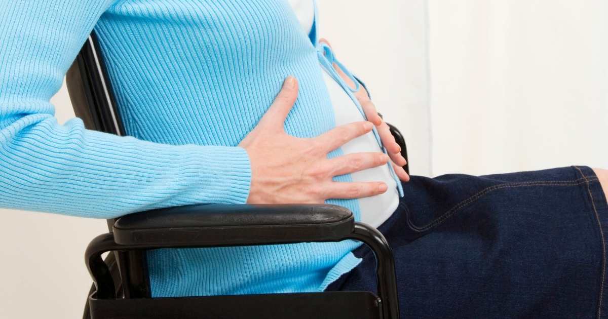 pregnant woman holding her belly