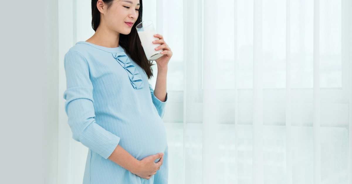 pregnant woman drinking ensure
