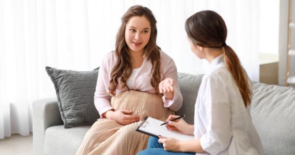 teen mom talking to educator